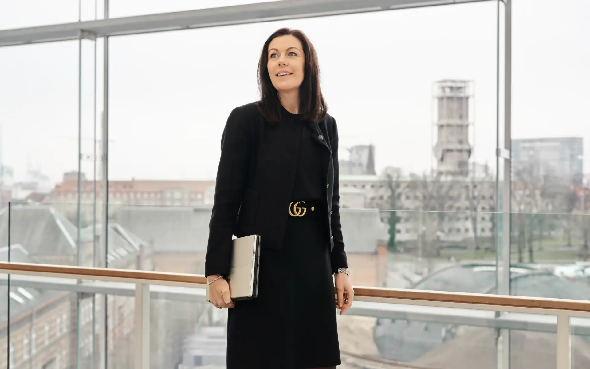 Louise Hahn looking out over Aarhus city skyline from a glass corridor