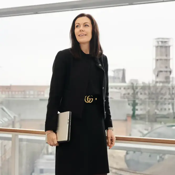 Louise Hahn looking out over Aarhus city skyline from a glass corridor