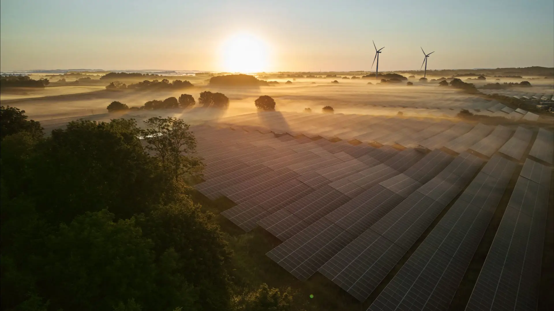 Nordic solar park and wind farm feeding a power purchase agreement into the transmission grid at dawn