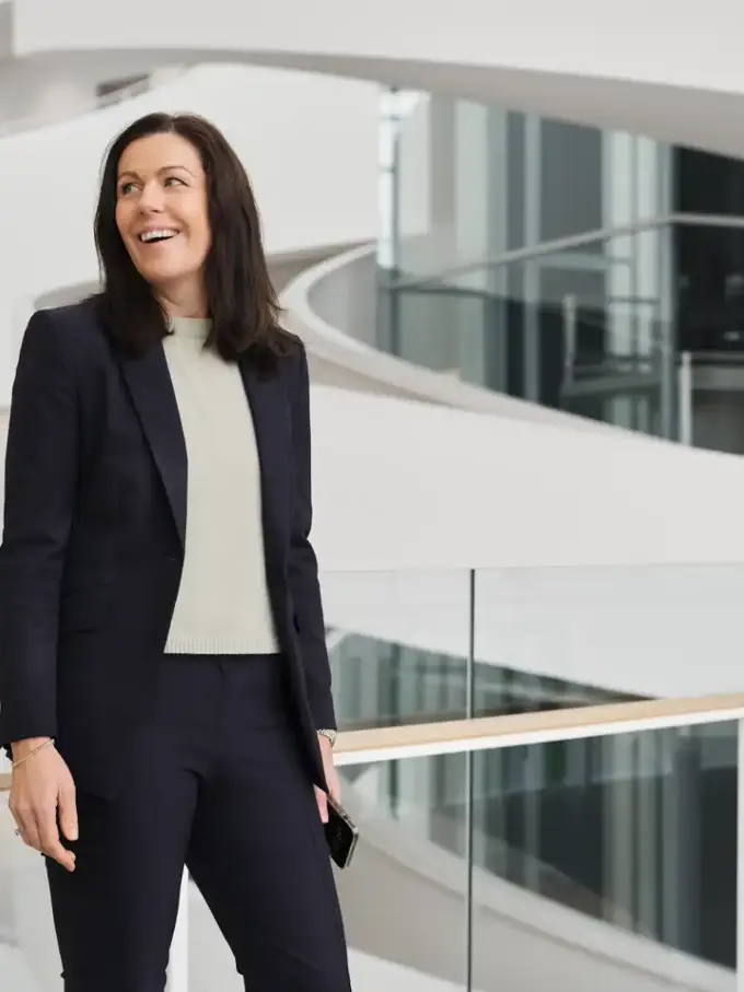 Louise Hahn smiling in a light-filled corporate space
