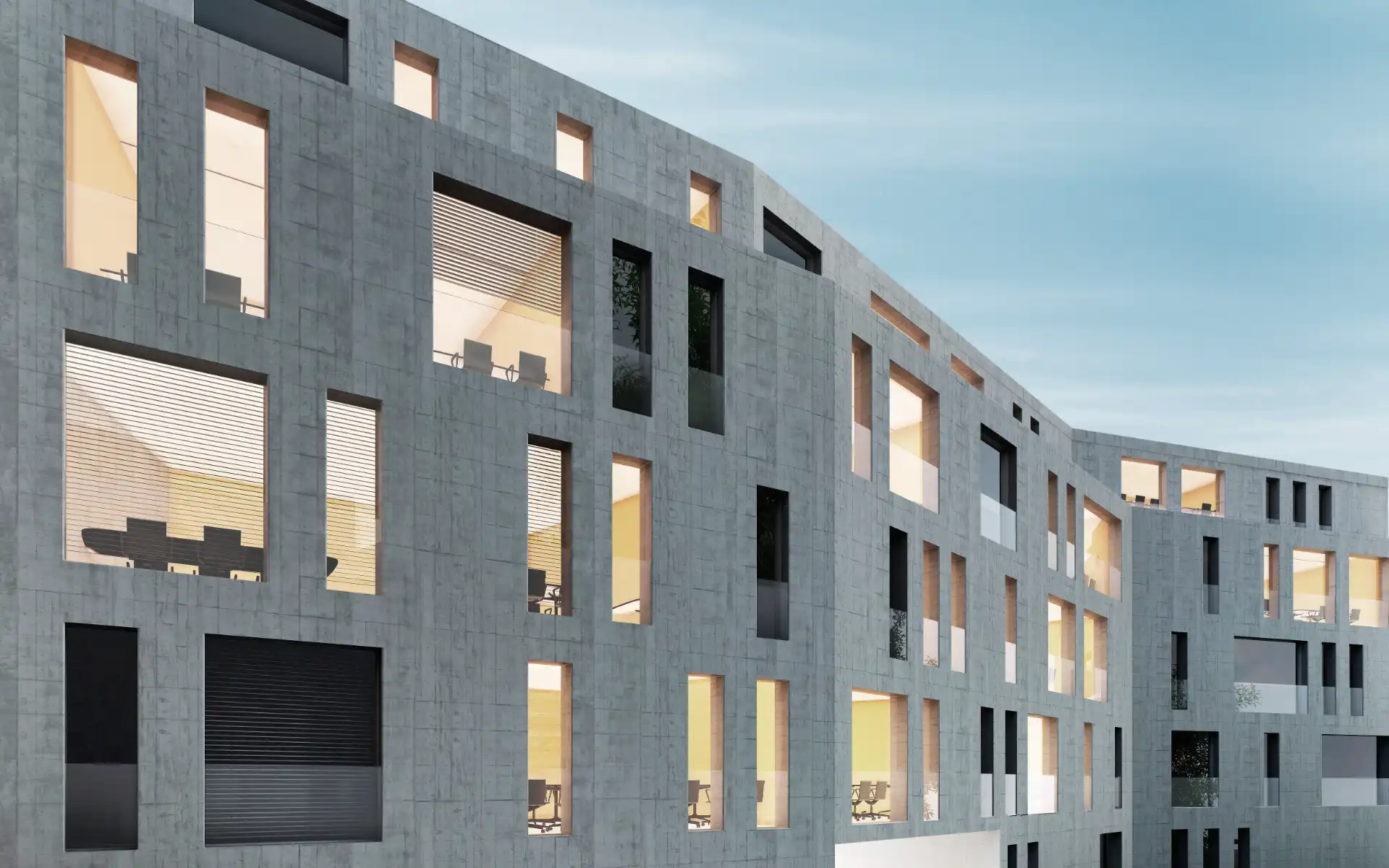 Sustainable office building with a geometric concrete facade and warm interior lighting.