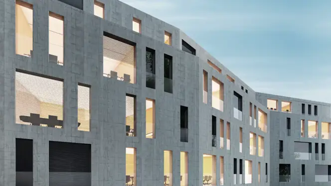 Sustainable office building with a geometric concrete facade and warm interior lighting.